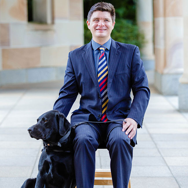 This is an image of Associate Professor Paul Harpur with his guide dog, Sean. 