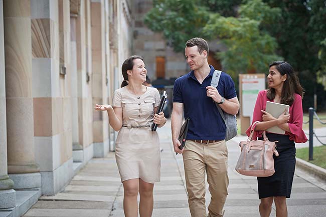 group of cheerful students walking through The Great Court