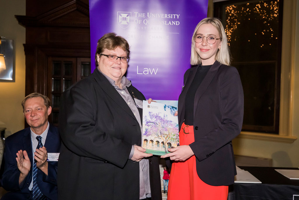 Grace Vipen accepting a law award from Terri Mottershead