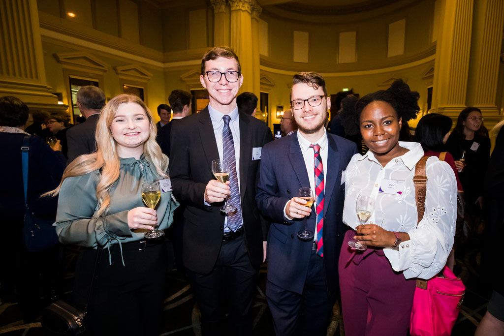 A group of four law students standing together at the 2021 UQ Law Awards