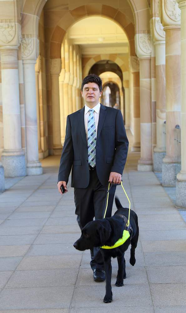 Associate Professor Paul Harpur walking his late dog, Chester at the Great Court