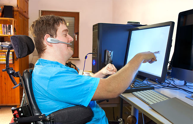 Man with cerebral palsy using a computer