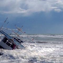 A small boat shipwrecked on a  beach