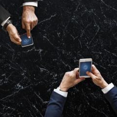 Two people using phones