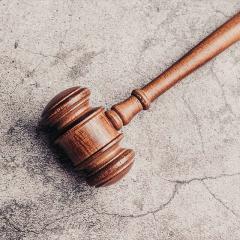 A judge's gavel lying on the concrete ground
