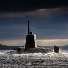 A submarine rising out of the water.