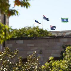 Flags on the Forgan Smith building