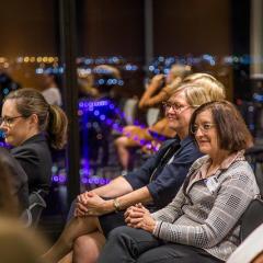 audience with city lights in background