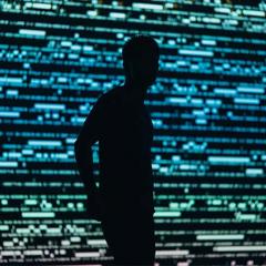 silhouette in front of a digital screen