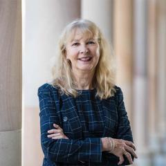 CPICL Fellow Professor Emerita Jennifer Corrin standing in UQ's Great Court