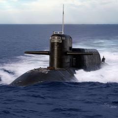 Nuclear submarine breaching waters in the open sea.