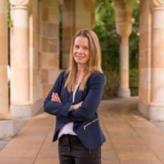 Professor Tamara Walsh, a caucasian lady, stands in a alley with columns either side. 