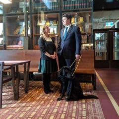 Pictured: Associate Professor Paul Harpur with his guide dog Sean, speaking to a colleague Dr Kathy Ellem. 