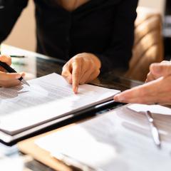 Two people looking at a contract