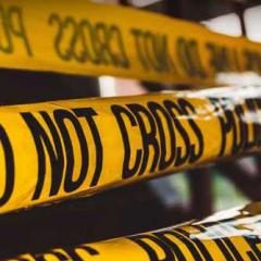 police tape at crime scene saying do not cross