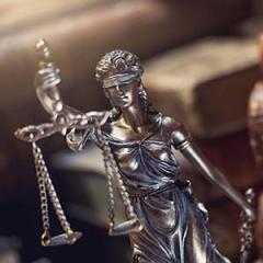 a small, metal statue of lady justice