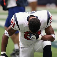 football player taking a knee