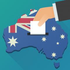 vector art of hand placing ballot paper into a slot in Australia.