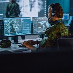 soldier at a computer console in digital war room 